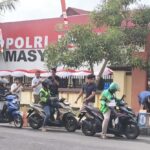 Kepedulian Polri, Subdit Tipidter Ditreskrimsus Polda Sulut Bagikan Ratusan Paket Makanan Gratis untuk Ojol